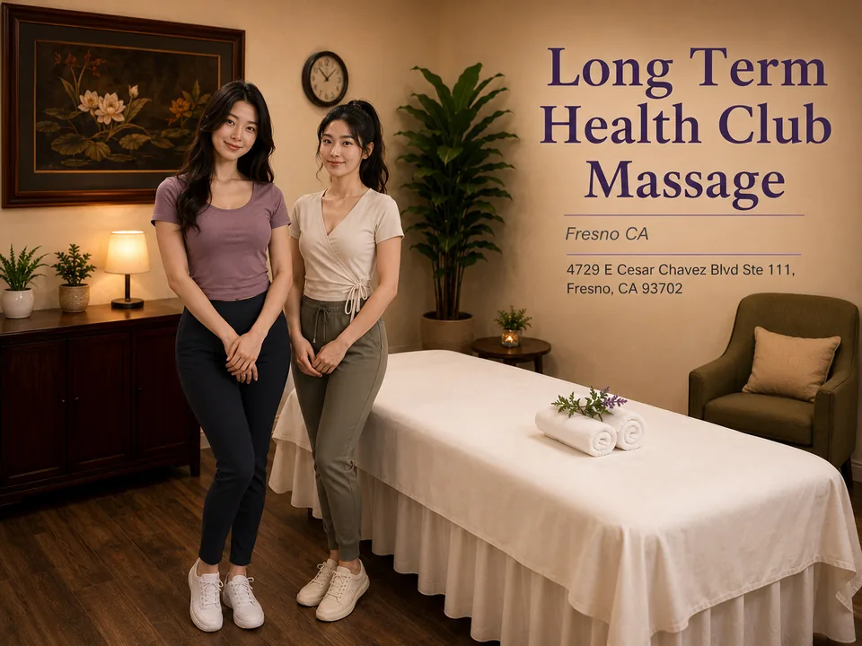 Two Long Term Health Club Massage therapists in a Fresno treatment room with the spa name and address