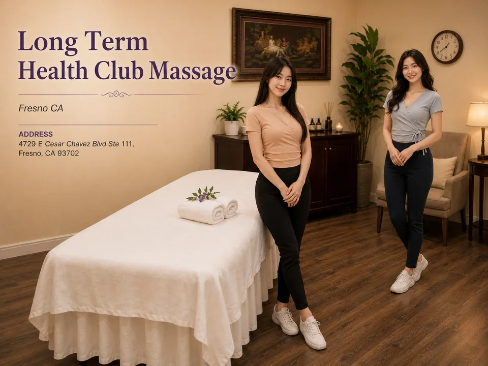 Two Long Term Health Club Massage therapists in a Fresno treatment room with the spa name and address