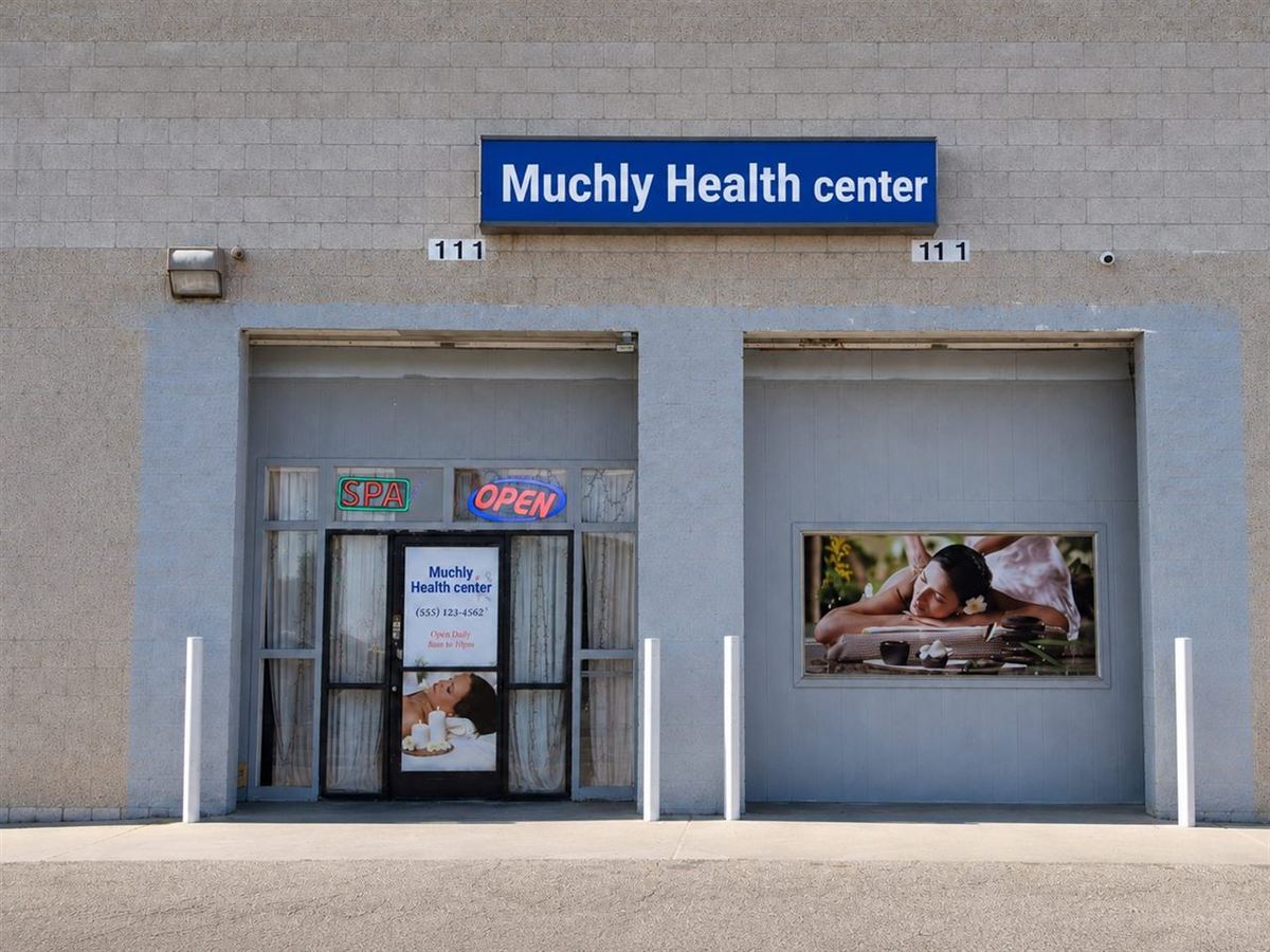Storefront of Muchly Health Center in Fresno CA with OPEN sign